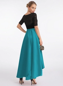 Detail of elegant black lace bodice paired with a shimmering lake blue pleated midi skirt
