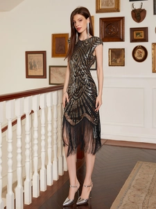 Detailed view of the Gatsby style geometric sequins and black fringe hem on the evening dress