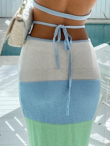 Detailed back view of striped knit set with lace-up bow and cross-strap design