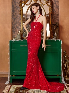 Detailed view of red sequin evening gown featuring a halter neck and drop-shaped cutout detail