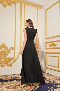 Elegant black backless maxi dress with a hidden zipper and flared hem in a classic interior
