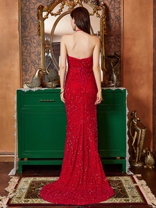 Detailed back view of red sequin evening gown with elegant lace-up corset closure