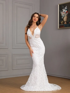 Elegant white lace mermaid evening gown with deep V-neck and a trailing hemline