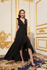 Detail of high-low ruffled hemline and waist tie on an elegant black V-neck evening dress