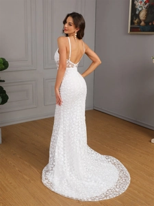 Elegant white lace dress showing a long circular train and backless design in detail