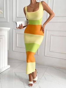 Detail of colorful striped knitted dress featuring yellow, green and orange patterns