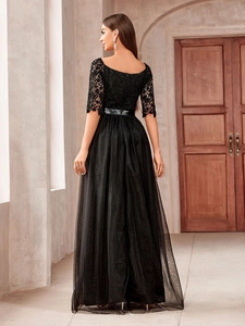 Elegant black off-shoulder evening gown with floral lace bodice and layered tulle skirt
