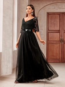 Detail of elegant V-neck lace bodice and layered mesh tulle skirt on a black evening gown