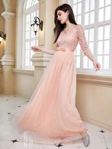 Detail of pink lace bodice with floral embroidery and V-neckline of evening gown