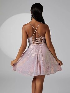 Detail of pink sequin dress showing backless design with delicate cross straps
