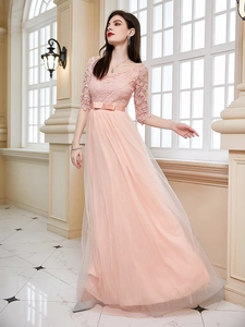 Detail of elegant lace bodice with V-neck and mesh layered skirt on a pink evening gown