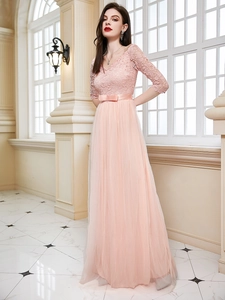 Elegant pale pink off-shoulder evening gown with lace bodice and layered tulle skirt