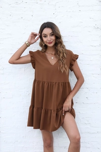 Detail of V-neck summer dress with tiered ruffle sleeves and layered skirt in brown
