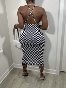 Detail of checkered halter dress showing open back design and bodycon fit on model