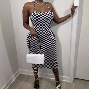 Sleeveless halter midi dress with black and white checkerboard pattern and bodycon fit