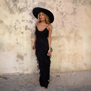 Elegant black sleeveless maxi dress with tiered ruffles and wide-brimmed sun hat