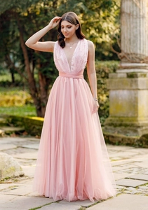 Close-up of pink halter dress bodice with pearl embellishments and pleated mesh detail
