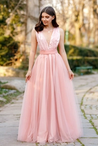 Detail of the elegant deep V-neck evening dress with handmade pearls and soft pink mesh