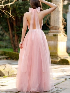 Pink halter neck backless tulle gown with oversized bow and tiered skirt for formal events