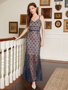 Close-up of navy lace floral embroidery and semi-sheer hemline on high-slit maxi dress