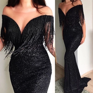Elegant black sequin evening gown featuring a deep V-neck and decorative fringe