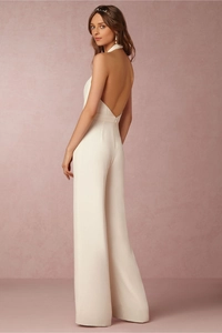 Elegant white backless wide-leg jumpsuit with halter neckline and high-waist design