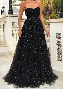 Detail of black strapless evening dress with colorful sequins and mesh A-line skirt