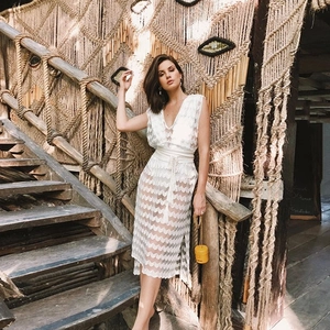 Elegant white V-neck sleeveless lace dress with crochet texture and beach resort style