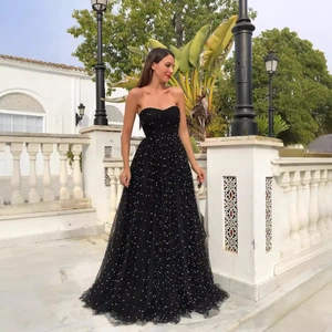 Elegant strapless black gala gown with colorful sequins on light tulle and high-waist silhouette