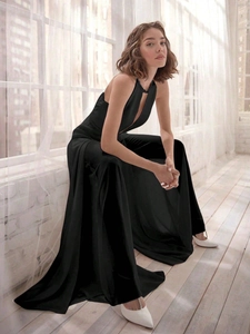 Detail of elegant black halter jumpsuit with refined dark rhinestone trim at the neckline