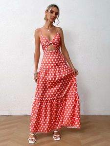 Detail of red polka dot maxi dress featuring front knot cutout and tiered ruffle hemline