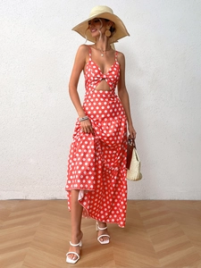 Detail of red polka dot dress with V-neck, bow tie, and cut-out in French holiday style