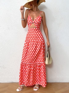 Detail of red polka dot maxi dress with V-neck cutout and tiered skirt for summer