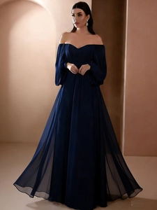 Detail of off-shoulder neckline and lantern sleeves on this dark blue evening gown