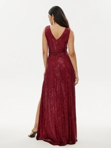 Detail of burgundy sequin evening gown showing deep V-back design and waist pleats