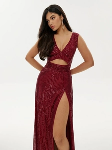 Detail of burgundy sequin evening dress featuring waist cut-outs and a high side slit