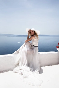 Close-up of white lace bodice and tiered chiffon skirt for elegant resort wear