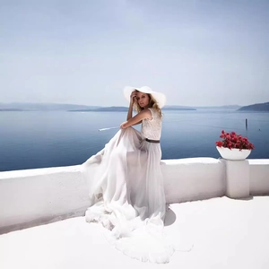 Elegant white sleeveless maxi dress in lace and chiffon with a waist belt for women
