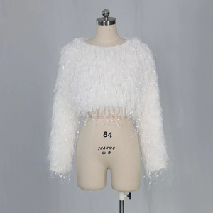 Detailed view of white long sleeve fuzzy knit cropped sweater with shimmering sequins