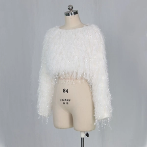 Detail of white feather knit sweater featuring sparkling sequins and fringe texture