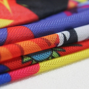 Macro shot of breathable mesh fabric featuring colorful geometric prints and soft texture