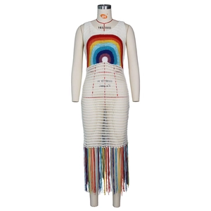 Détail de robe de plage crochet blanc avec motif arc-en-ciel et pompons à franges colorés