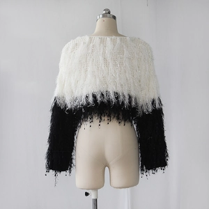 Detail of black and white contrast cropped sweater showing fluffy long fringe texture