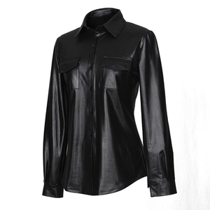 Macro detail of the high-shine black PU leather texture and lapel collar of this women shirt