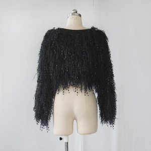 Detailed view of black cropped sweater with fringe texture and subtle sequin embellishments