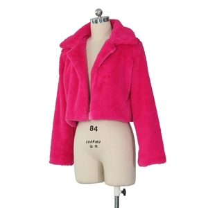 Close-up of rose red faux fur jacket showing thick fluffy texture and lapel design