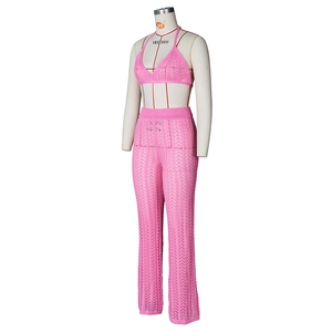 Detail of pink crochet knit two-piece set featuring hollow wave pattern on wide-leg pants