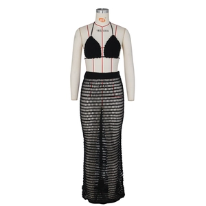 Detail of black crochet knit two-piece set featuring mesh hollow beach cover-up texture