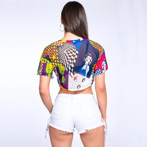 Back view of model wearing a cropped mesh T-shirt with pop art print and white shorts
