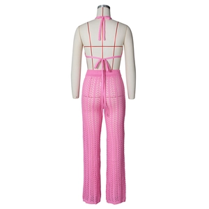 Detail of pink crochet knit mesh texture on backless halter top and wide leg pants